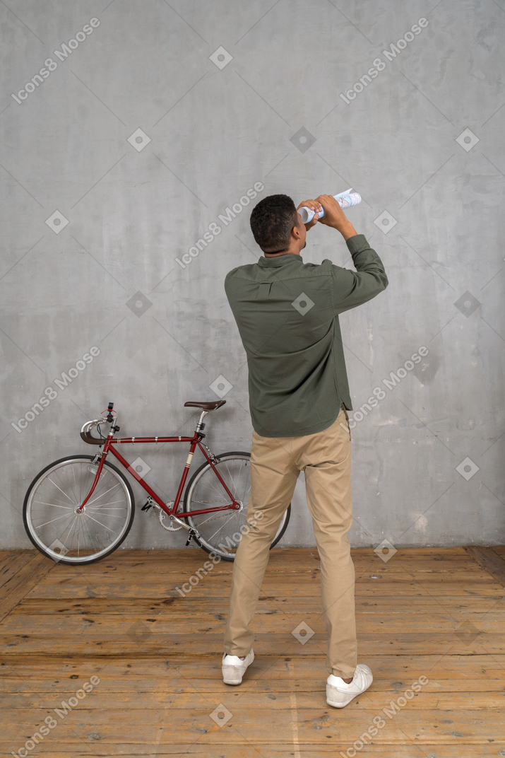 Man looking into the map telescope like