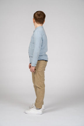 Boy in casual clothes standing in profile