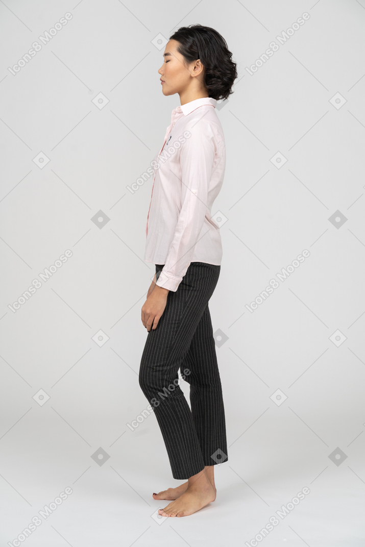 Side view of a woman in office clothes with closed eyes