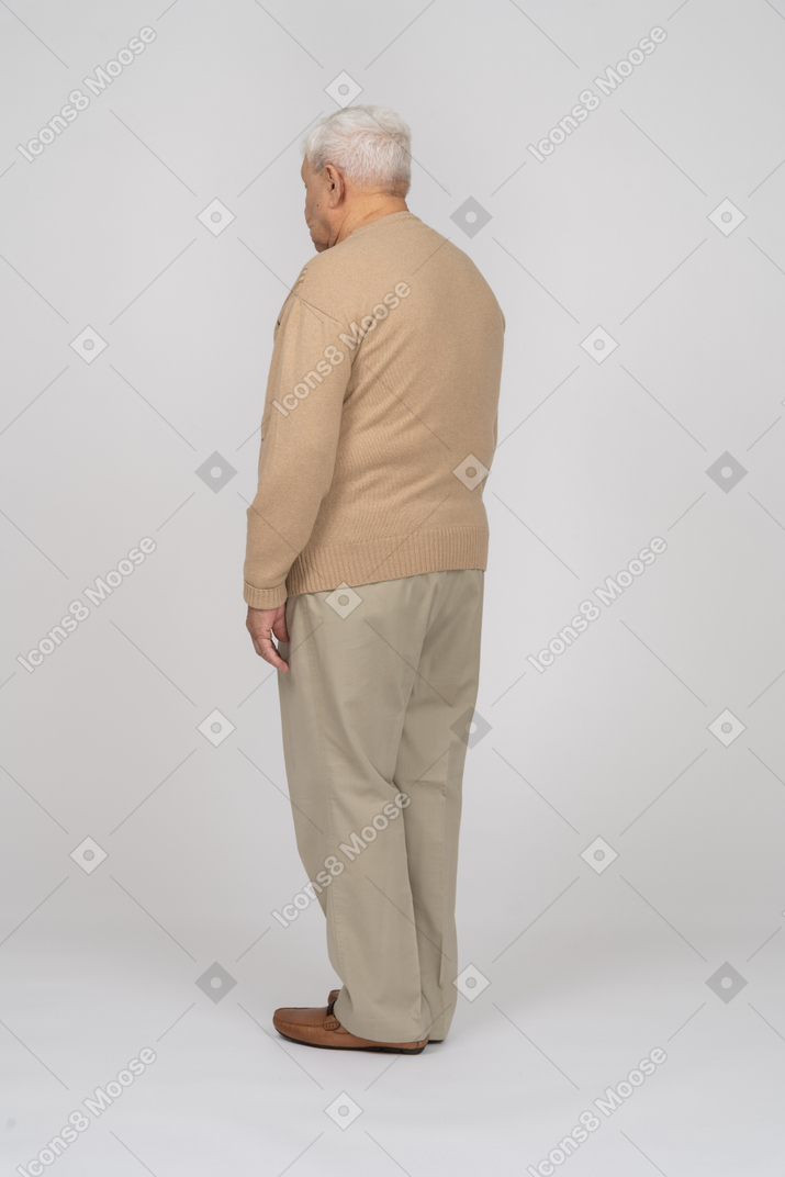 Side view of an old man un casual clothes standing still