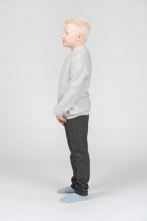 Side view of a calm little boy with folded hands