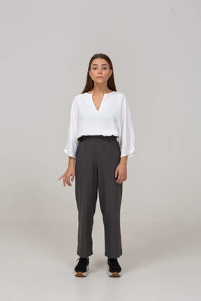 Front view of a young lady in office clothing looking at camera