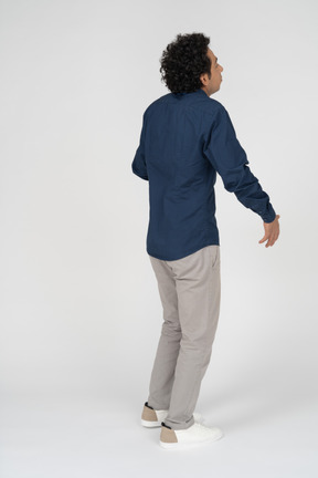 Rear view of a man in casual clothes posing