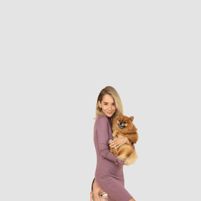 A woman holding a dog in her arms