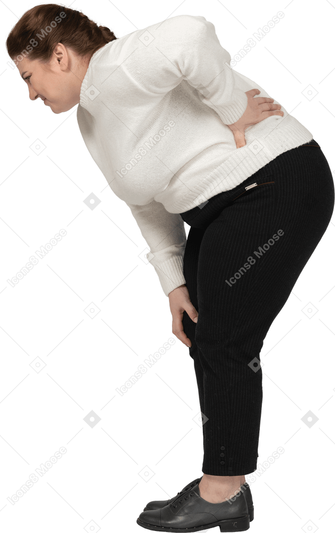 腰の痛みに苦しんでいる白いセーターのプラスサイズの女性