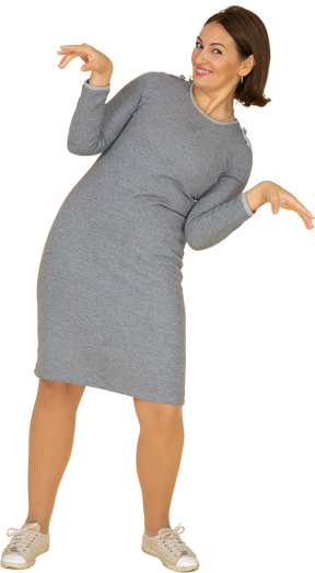 Front view of a happy woman in grey dress