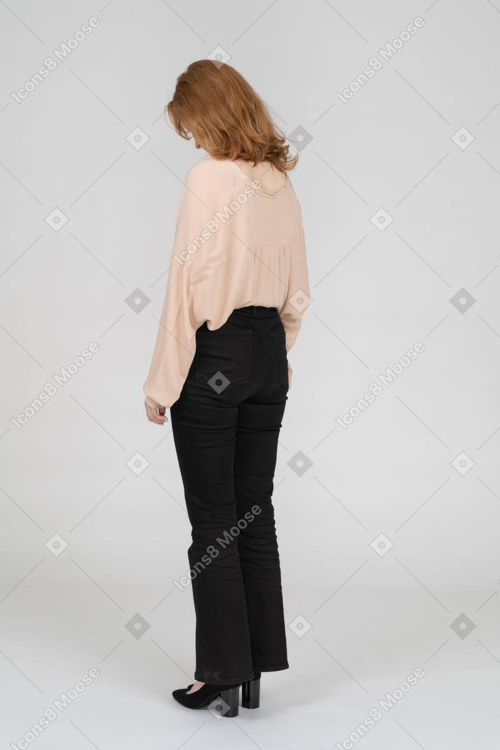 Young woman standing with head down
