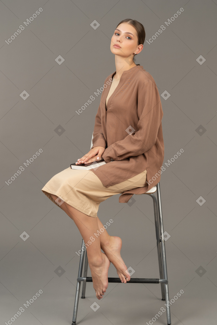 Young woman sitting and looking at camera