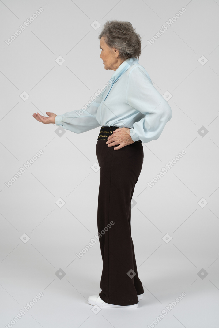 Side view of an old woman stretching out her hand begging