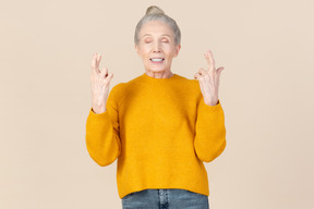 Elegant older woman in a mustard sweater