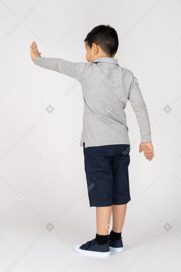 Little boy showing stop sign