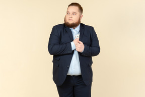 A plus-size man in a black costume with dollar bills in his hands