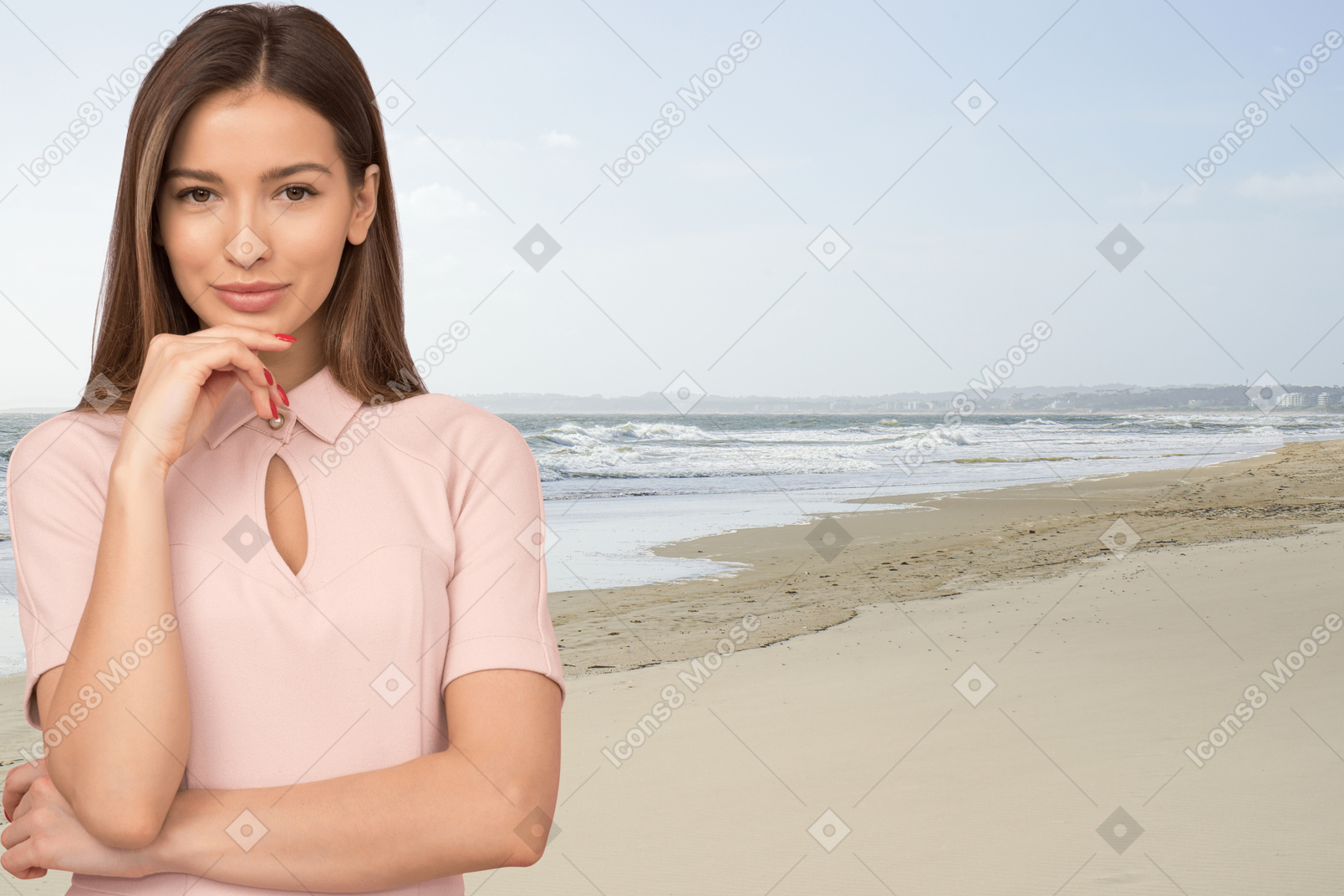 A woman standing on a beach next to the ocean