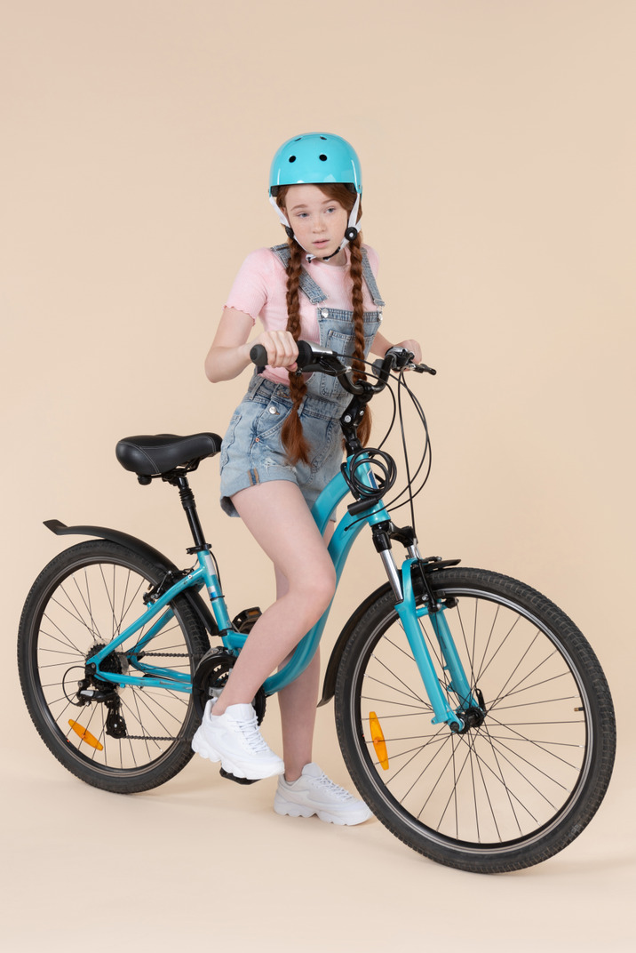 Teenage girl riding on bicycle