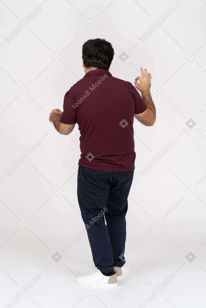 Back view of man showing ok sign