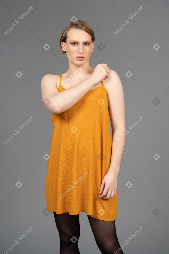 Young non-binary person adjusting dress strap