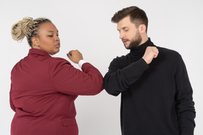 Colleagues greeting each other with elbow bump