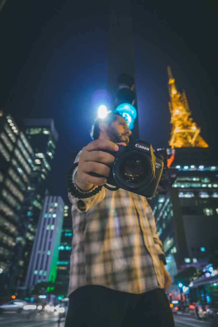 Front view of a man taking pictures with a camera