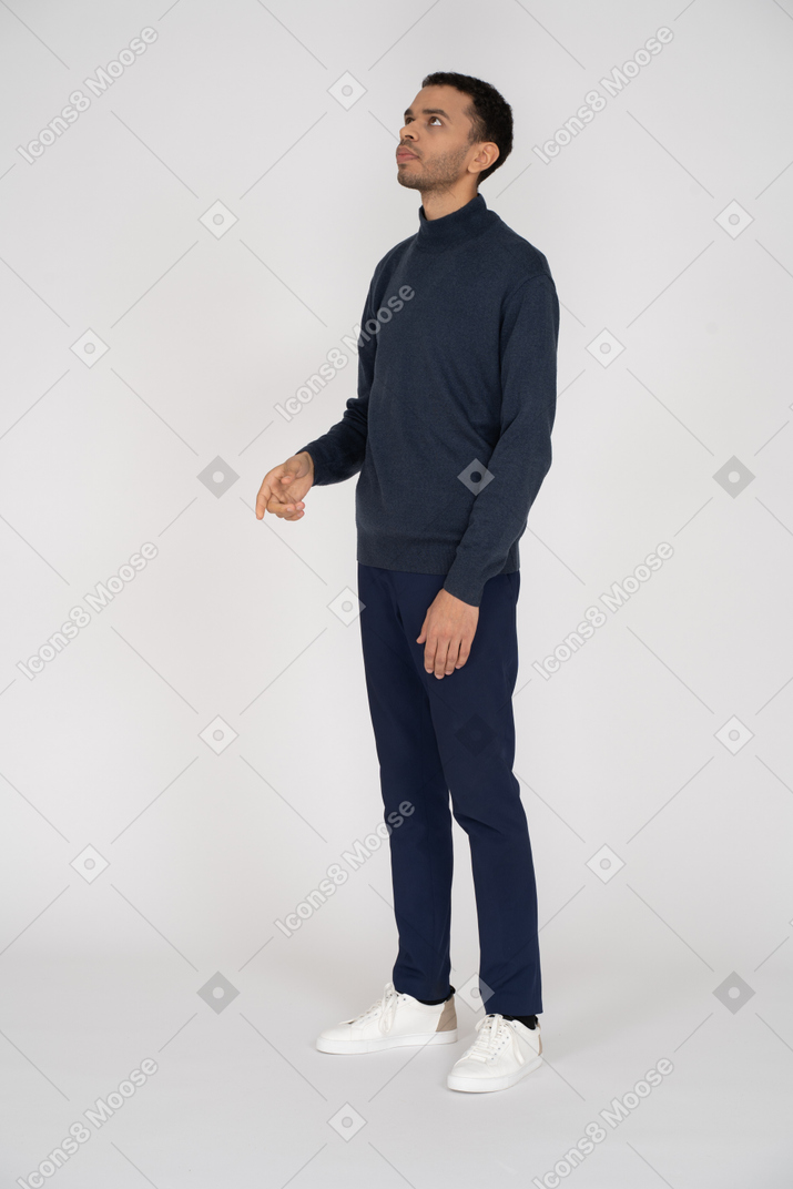 Man in casual clothes looking up