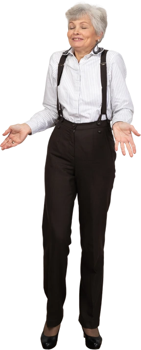 Front view of a smiling gesticulating old lady standing with her eyes closed