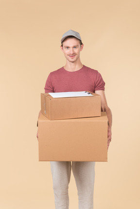 Delivery guy holding boxes with folder on it