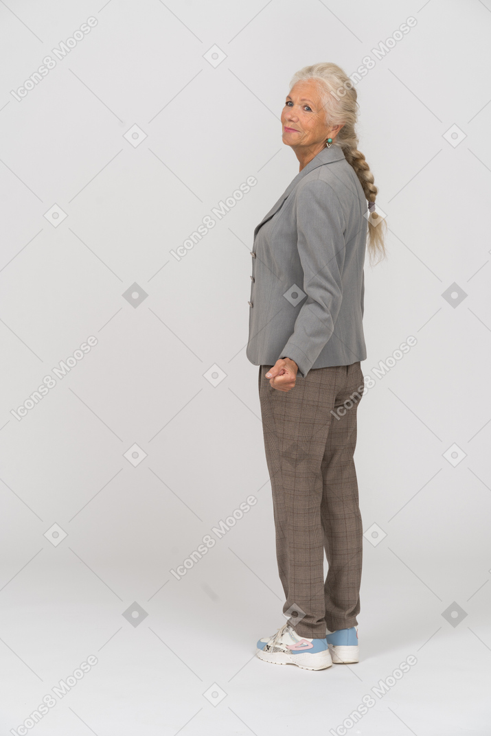 Rear view of a happy old woman in suit