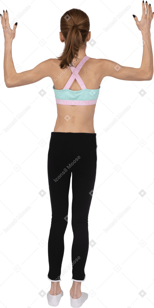 Back view of a surprised teen girl in sportswear raising hands