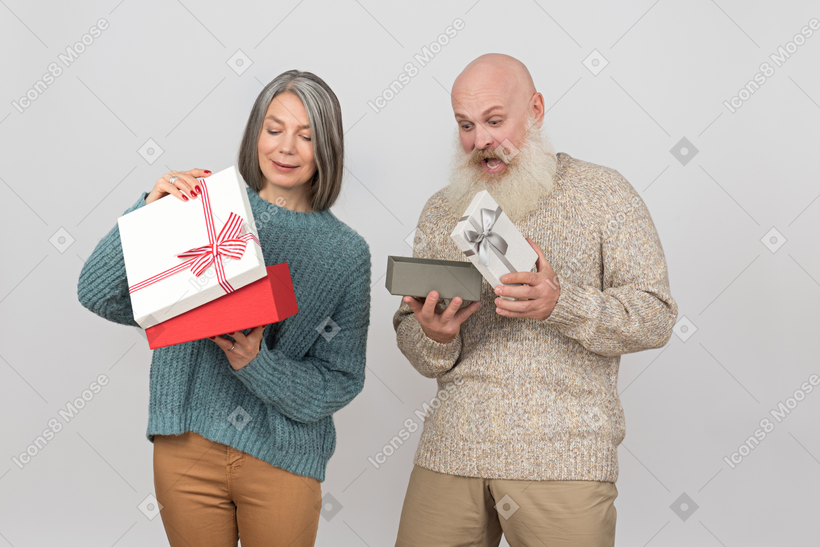Elegant elderly couple giving gifts to each other