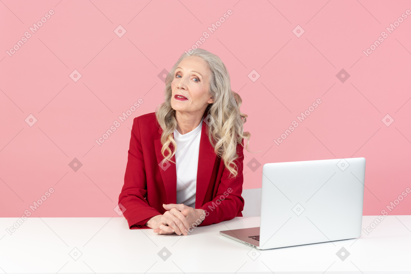 Aged female office worker sitting at the computer