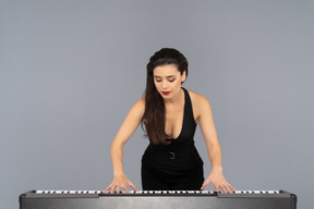 Young female pianist being focused on her playing