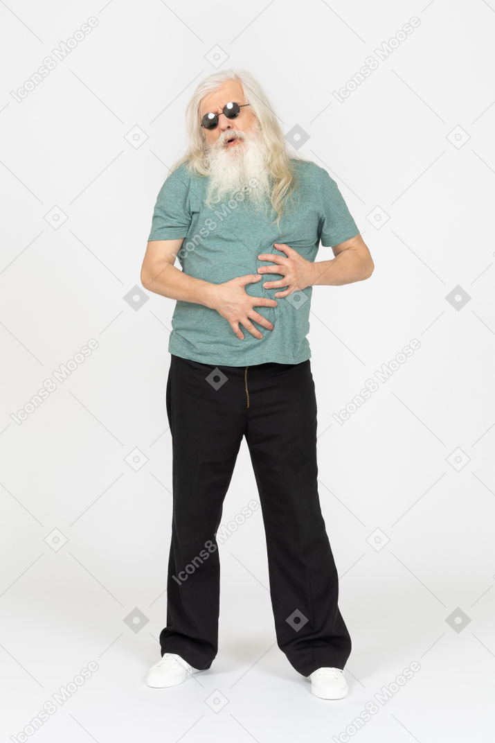 Front view of old man in sunglasses feeling stomach ache