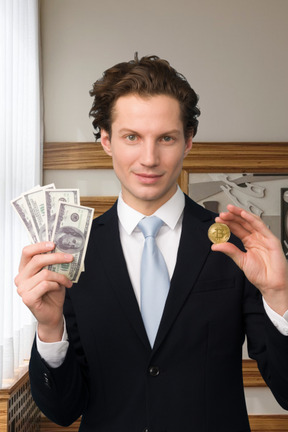 A man in a suit holding money and a coin