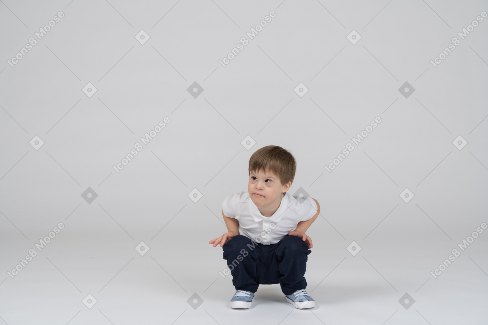 A boy standing in front of an empty wall