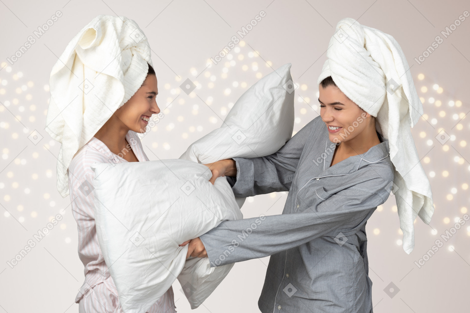 Two women having a pillow fight