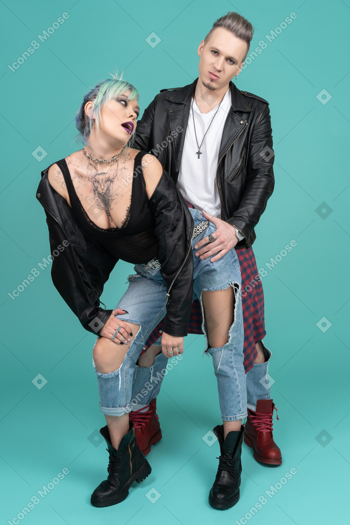Young man holding his girlfriend by the hips
