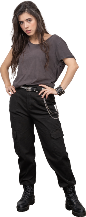 Front view of a displeased female rocker putting hands on hips