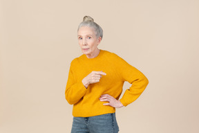 Elegante donna anziana con un maglione di senape