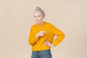 Elegant older woman in a mustard sweater