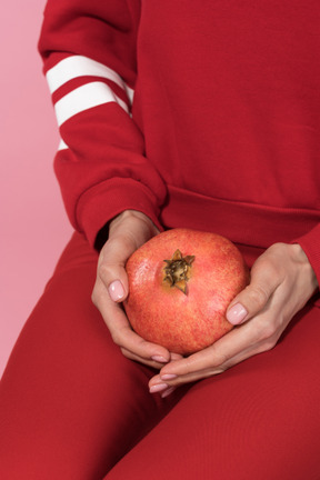Grapefruit in female`s hands