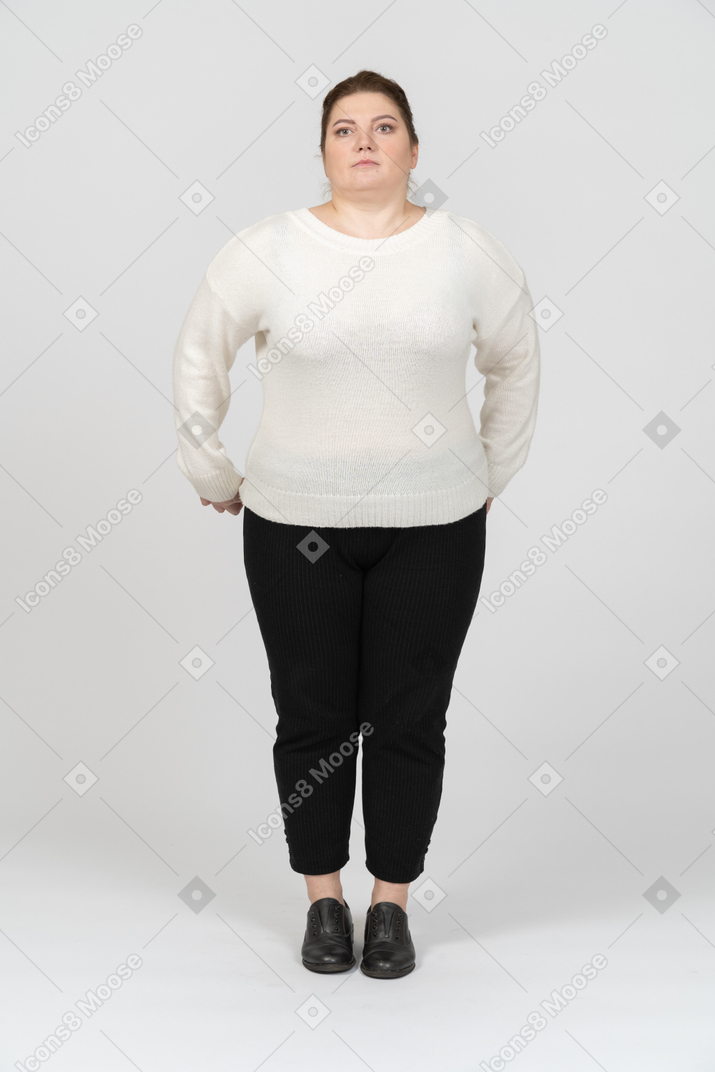 Mulher gorda e séria com roupas casuais olhando para a câmera