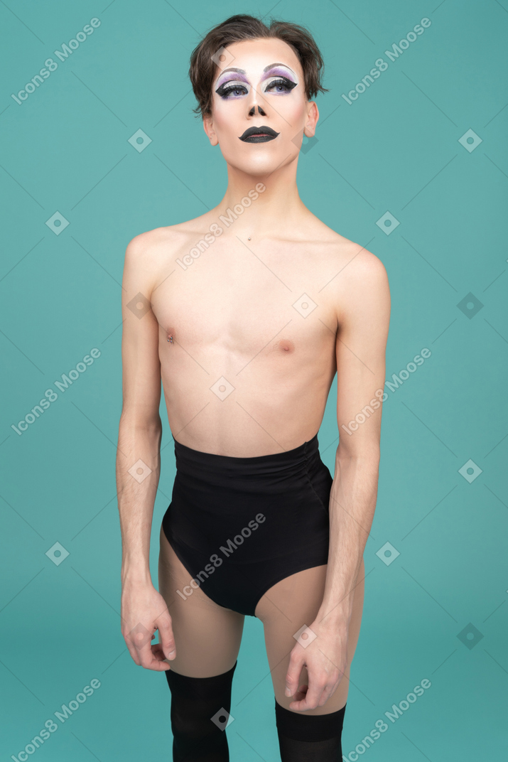 Drag queen standing with arms at sides