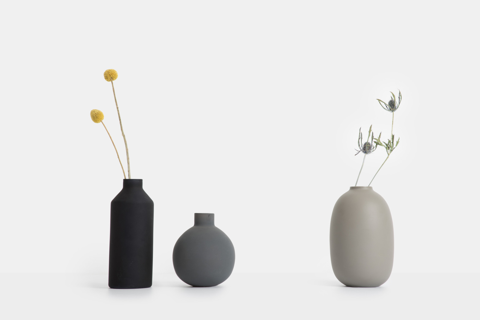 Three ceramic vases with dried flowers