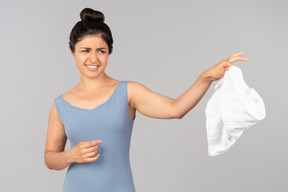 Young indian woman throwing towel away
