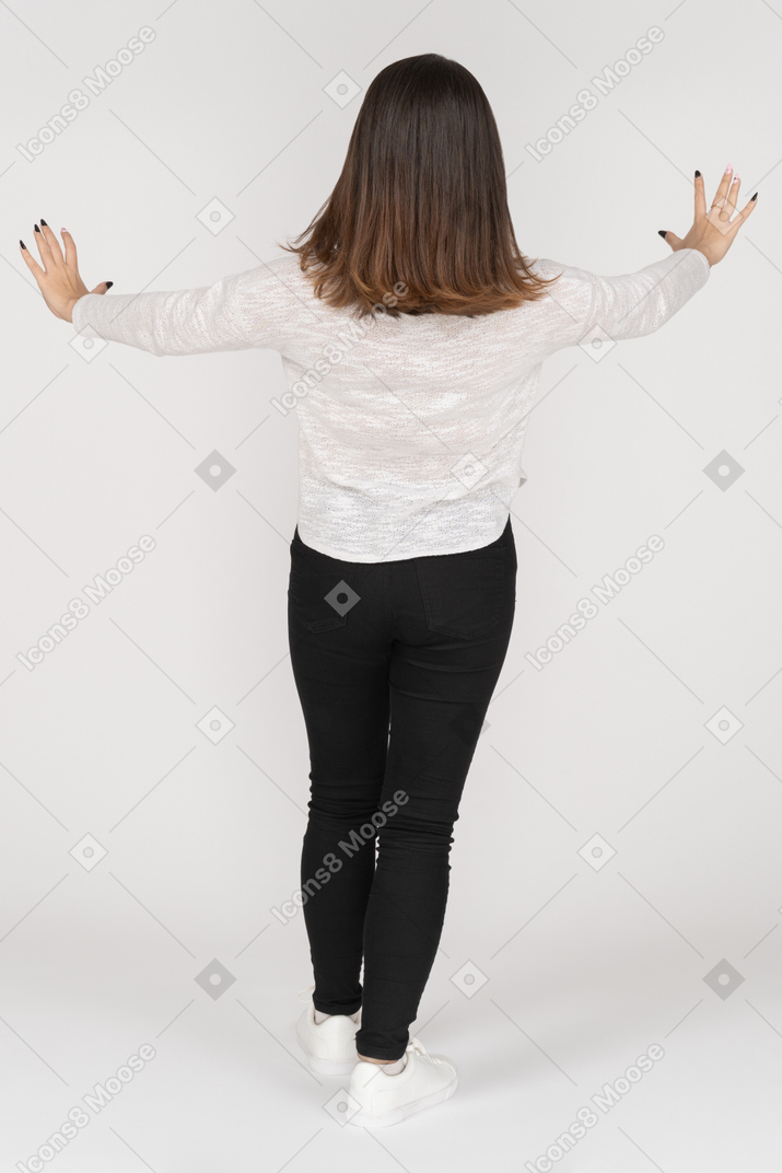 Unrecognizable brunette woman standing with outstretched arms
