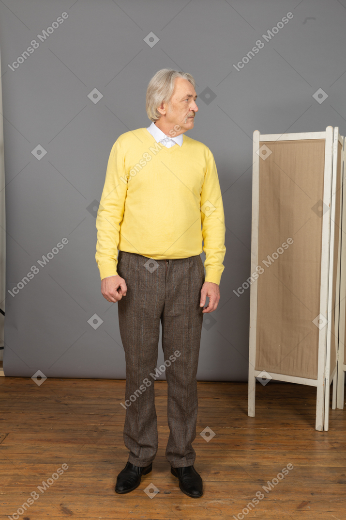 Front view of a displeased old man looking aside