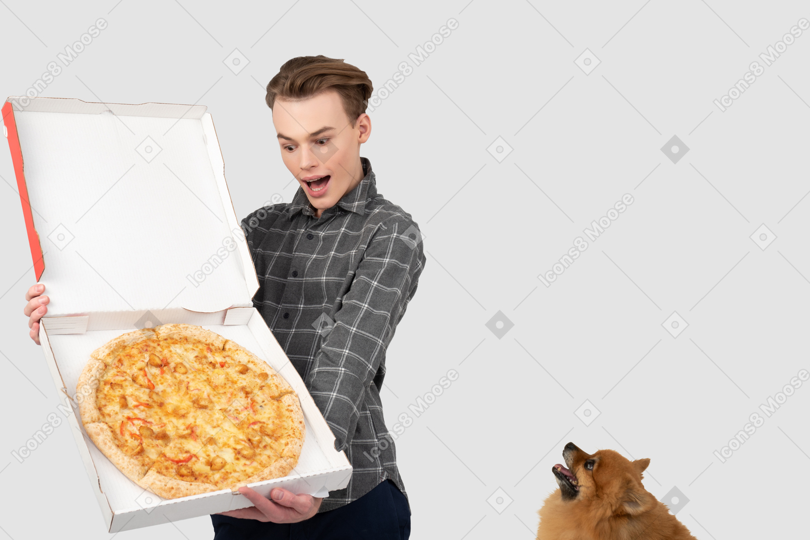 A man holding a pizza box with a dog in the background