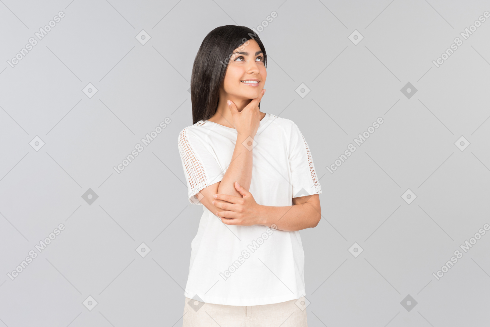 Dreamy young indian woman standing in comfy clothes