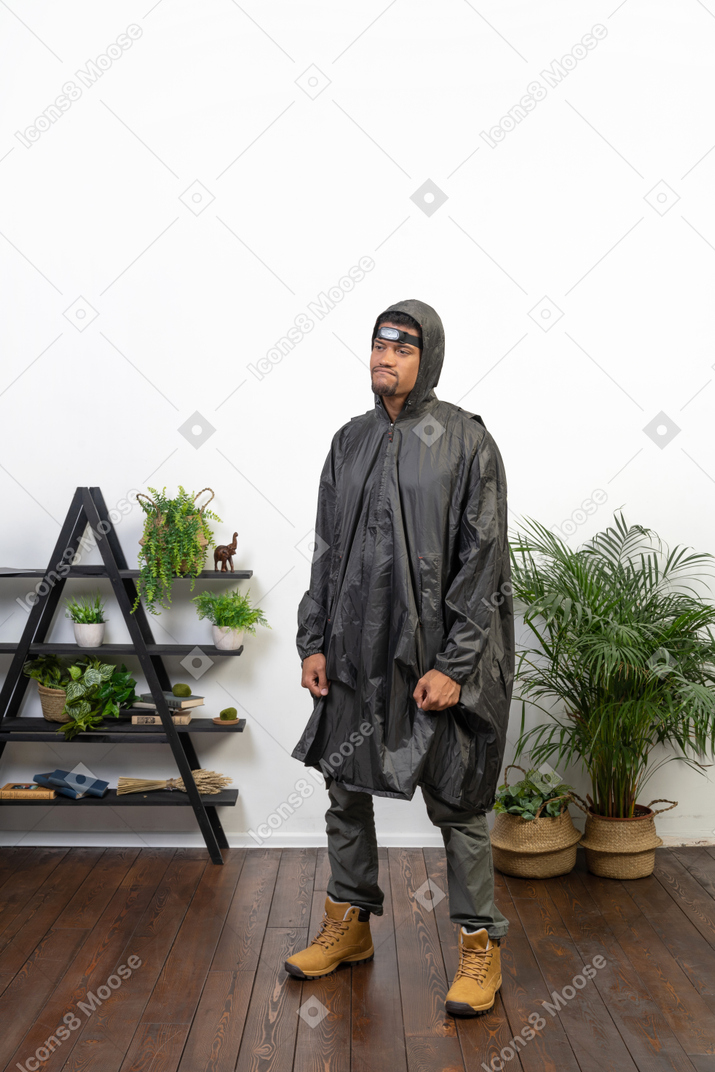 Mürrischer mann im regenmantel mit geballten fäusten
