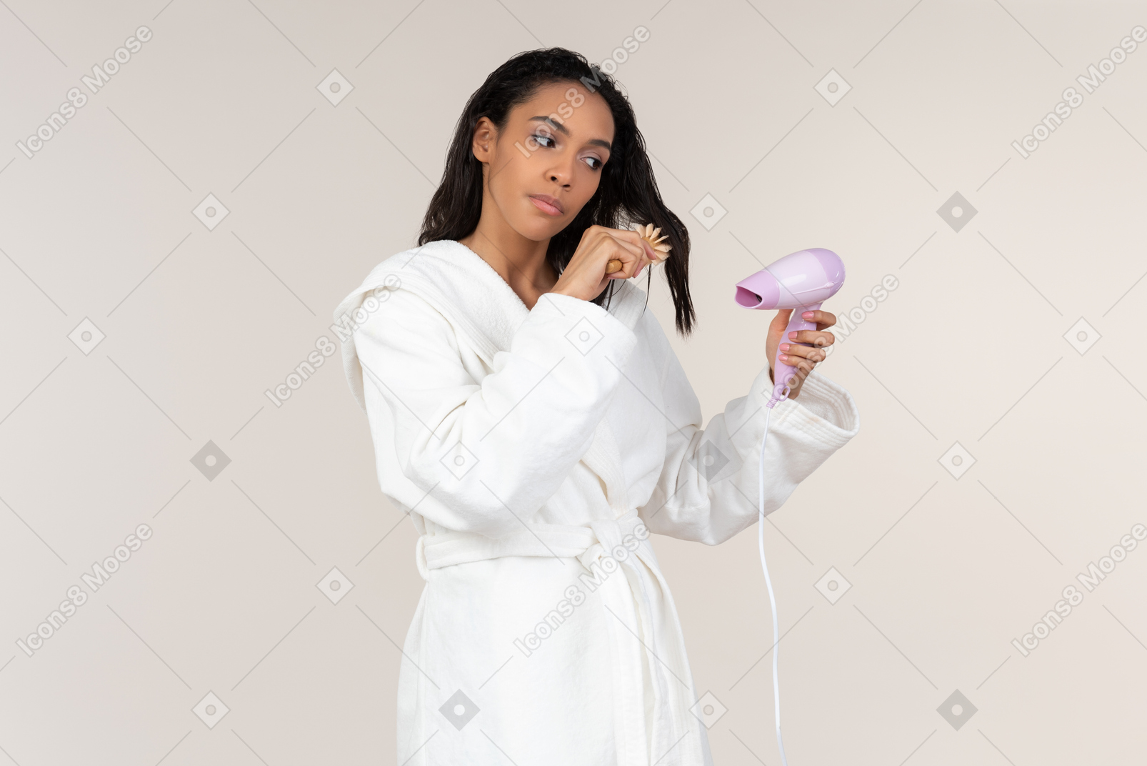 Dreamy young afrowoman drying hair with hair dryer