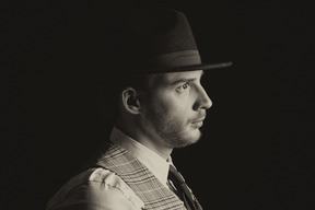 Portrait of a handsome gentleman in hat in profile